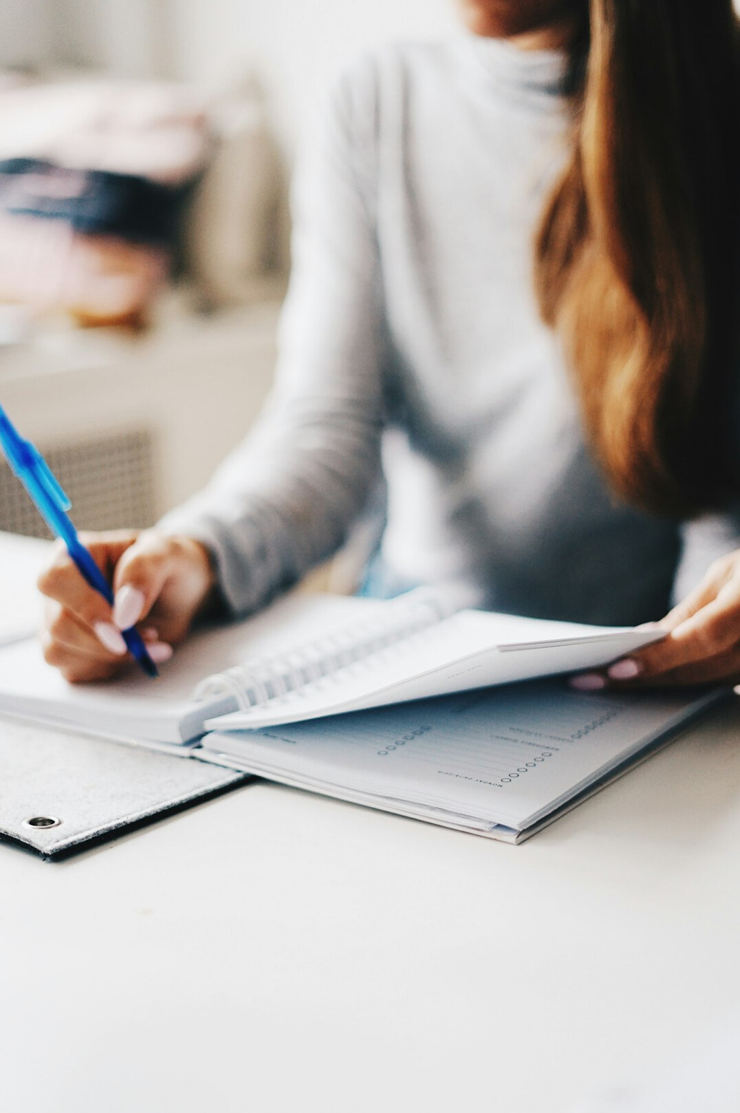 person writing in planner